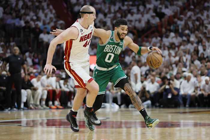 May 23, 2023; Miami, Florida, USA; Boston Celtics forward Jayson Tatum (0) controls the ball against Miami Heat center Cody Zeller (44) in the third quarter during game four of the Eastern Conference Finals for the 2023 NBA playoffs at Kaseya Center.